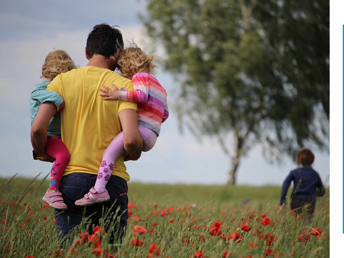 A man carrying two girls.